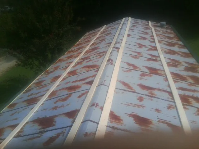 Rusted metal roof panels with new wood purlins before replacement — Storm Damage Roof Repair in Bostic by Roofing Brothers